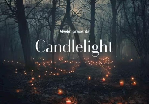 The image shows a foggy forest with numerous candles lit on the ground, accompanied by the text 