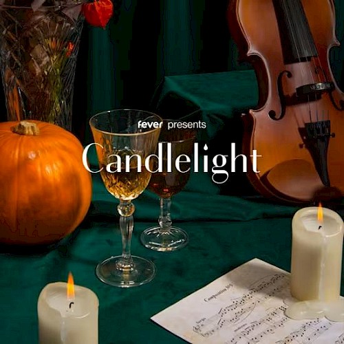 The image features candles, a pumpkin, wine glasses, sheet music, and a violin, with text 